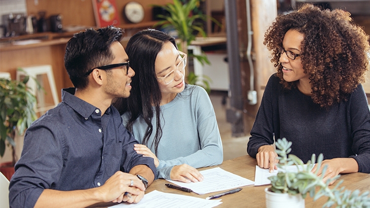 Couple meeting with home ownership advisor.