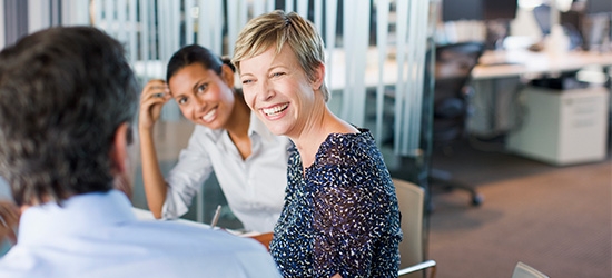 Women smiling in business meeting